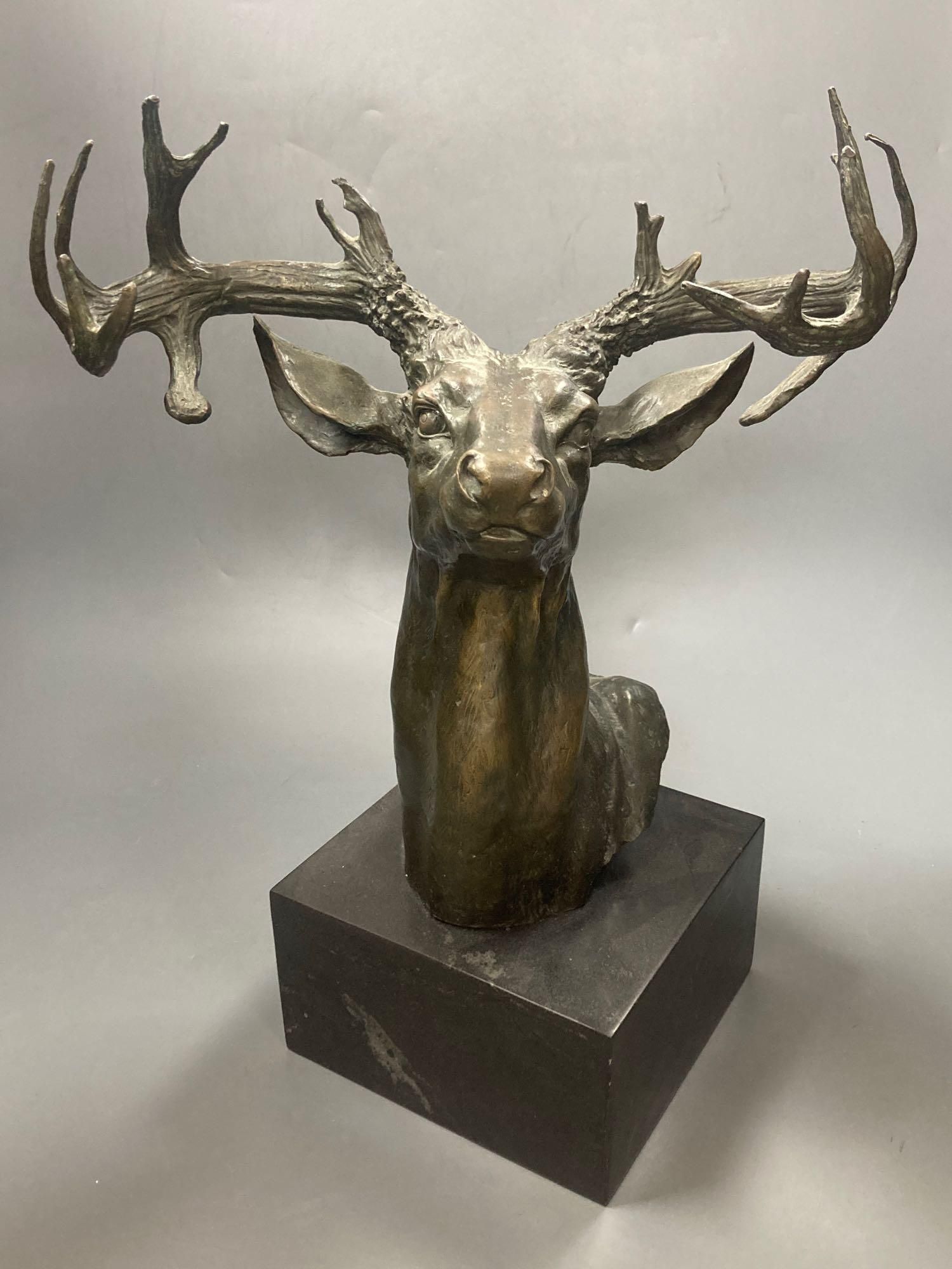 A bronze model of a stags head, 45cm including plinth